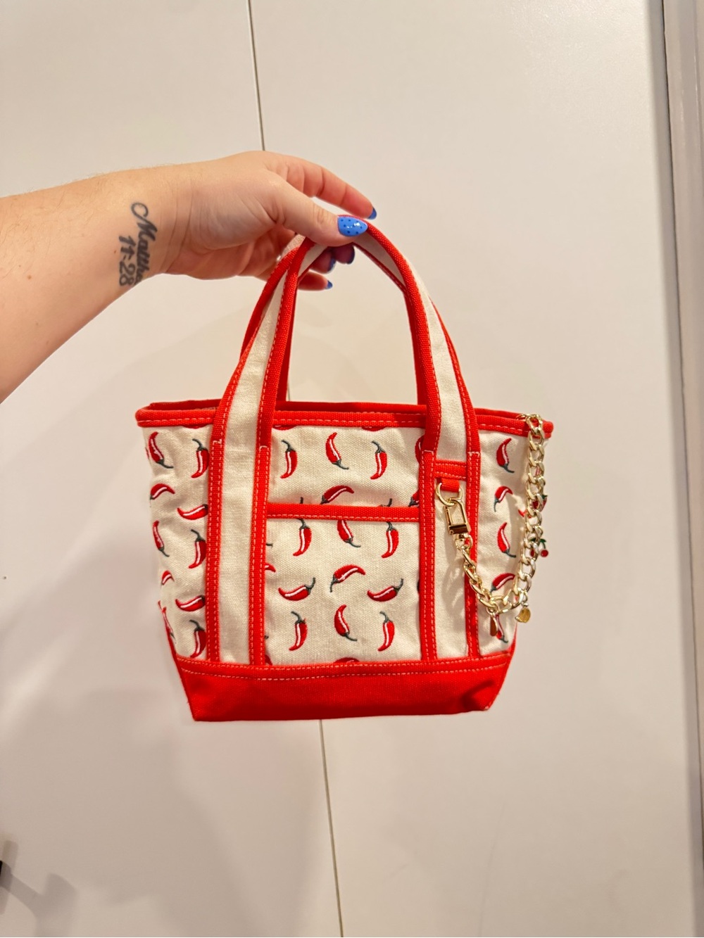 Red Chili-Print Canvas Tote Bag with wristlet and bag chain.